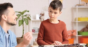 A man sitting with a child